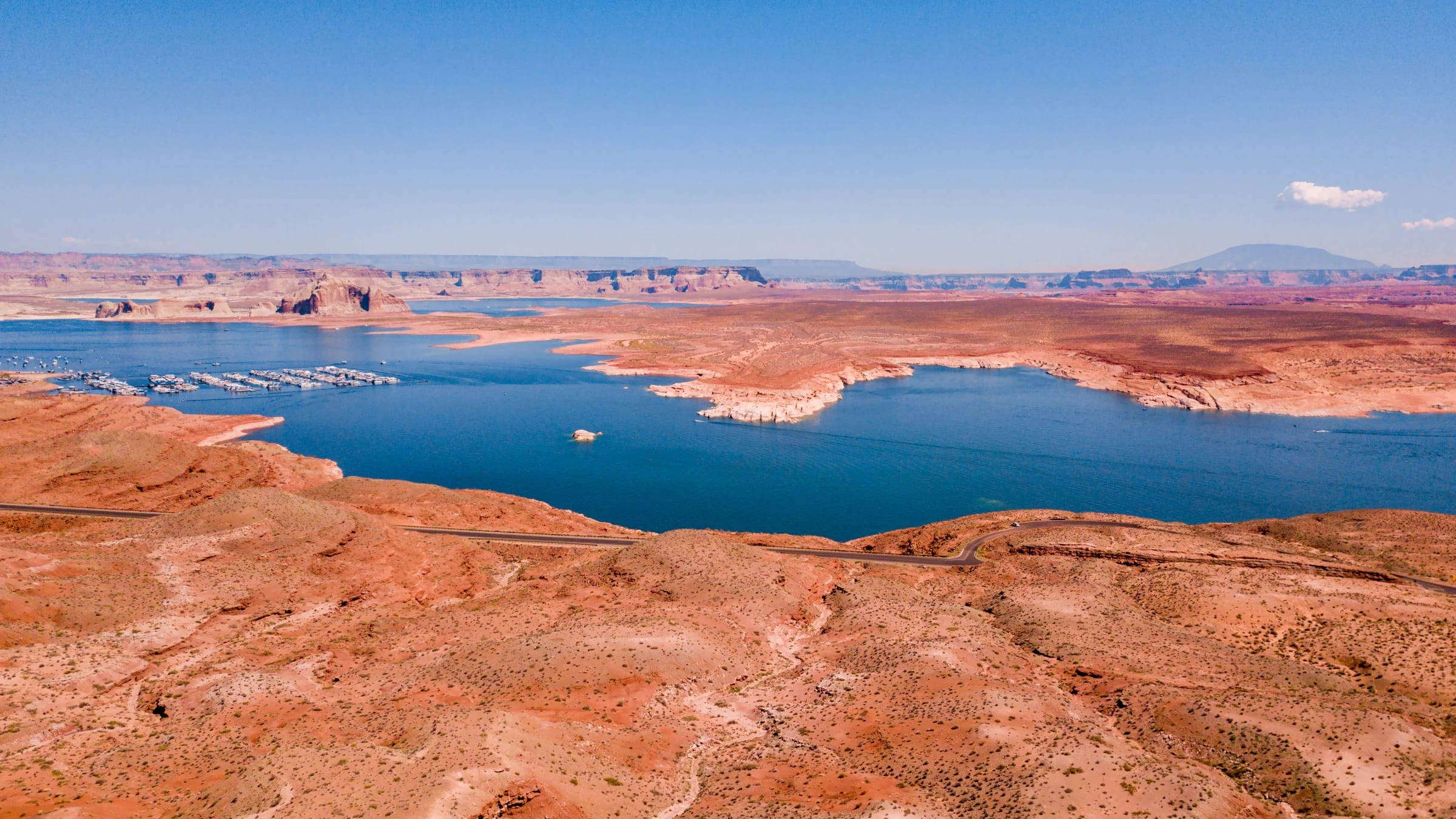 Aerial view of Lake Powell and Glen Canyon Dam in the desert landscape.