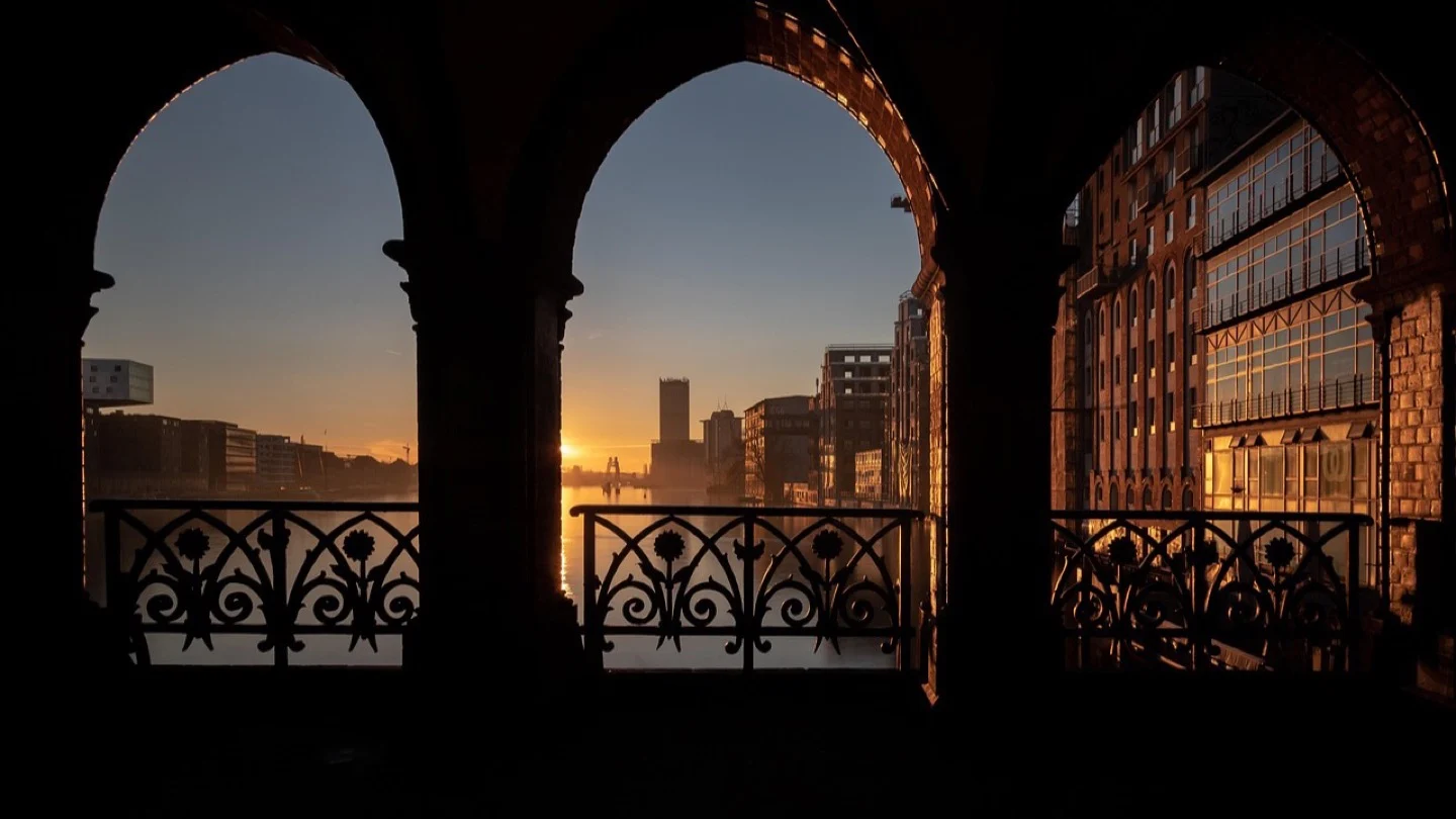 Berlin’s Oberbaum Bridge frames the Spree at sunset.