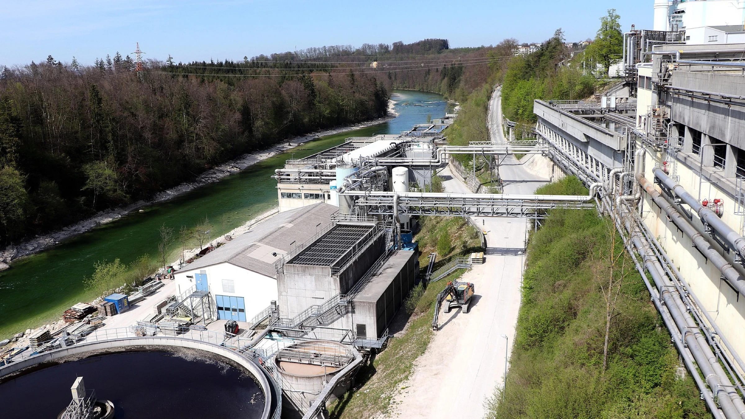 Aerial view of a wastewater treatment plant with multiple circular treatment basins.