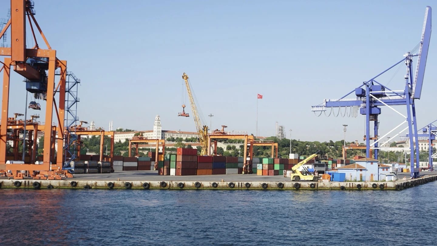 Container cranes and port infrastructure beside a working harbour