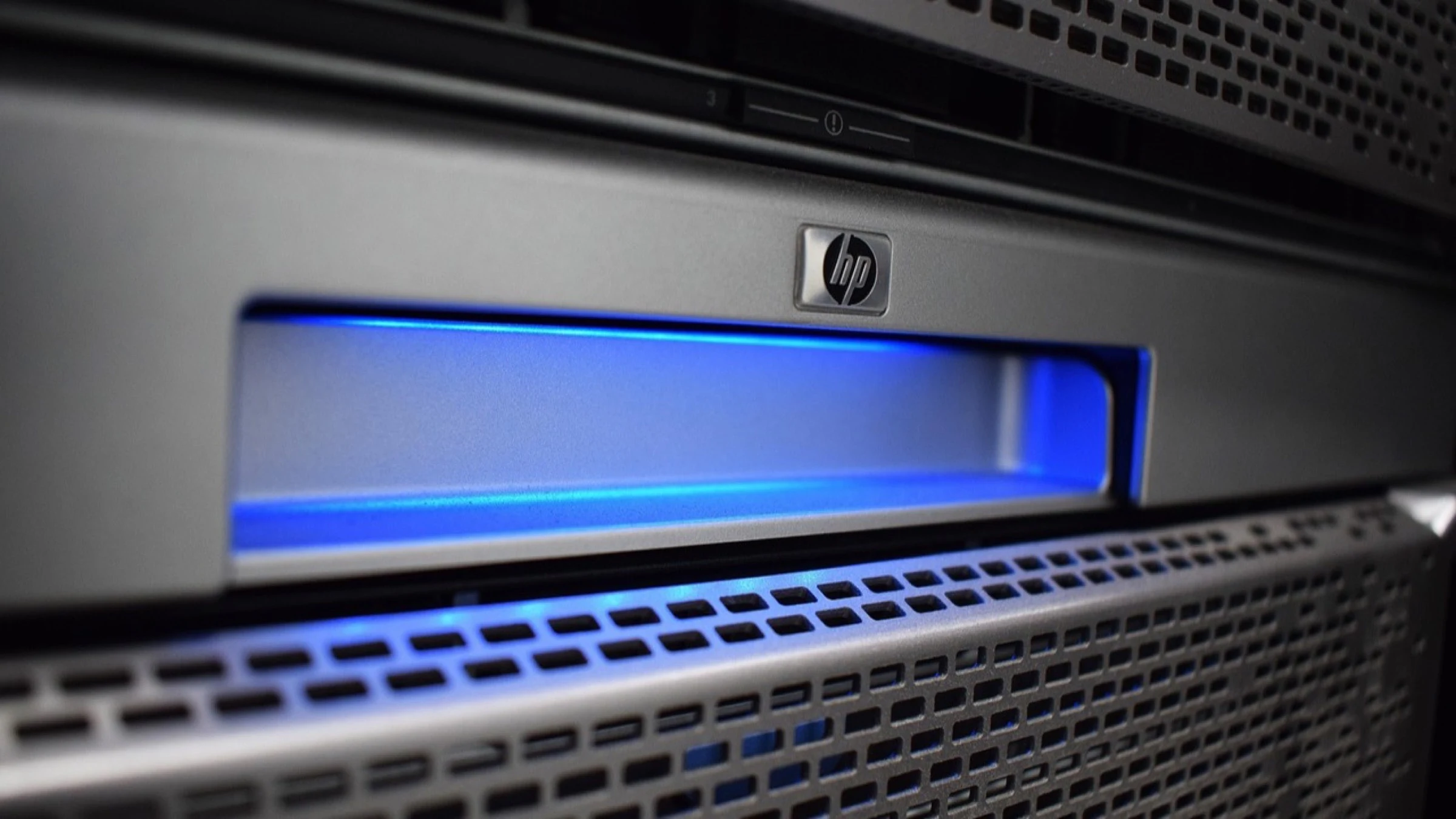 Rows of illuminated server racks inside a data center.