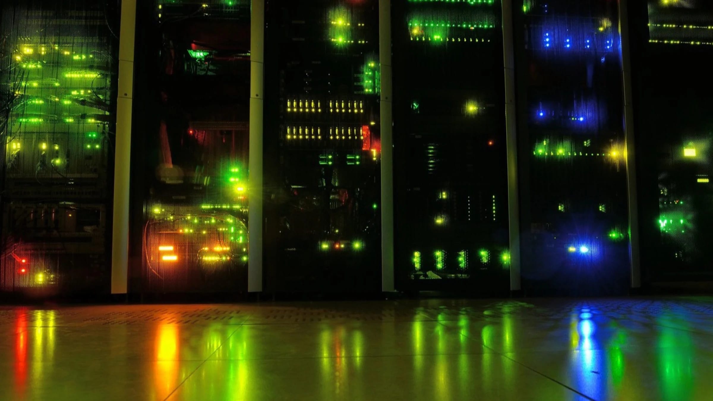 Illuminated server racks in a dark data center.