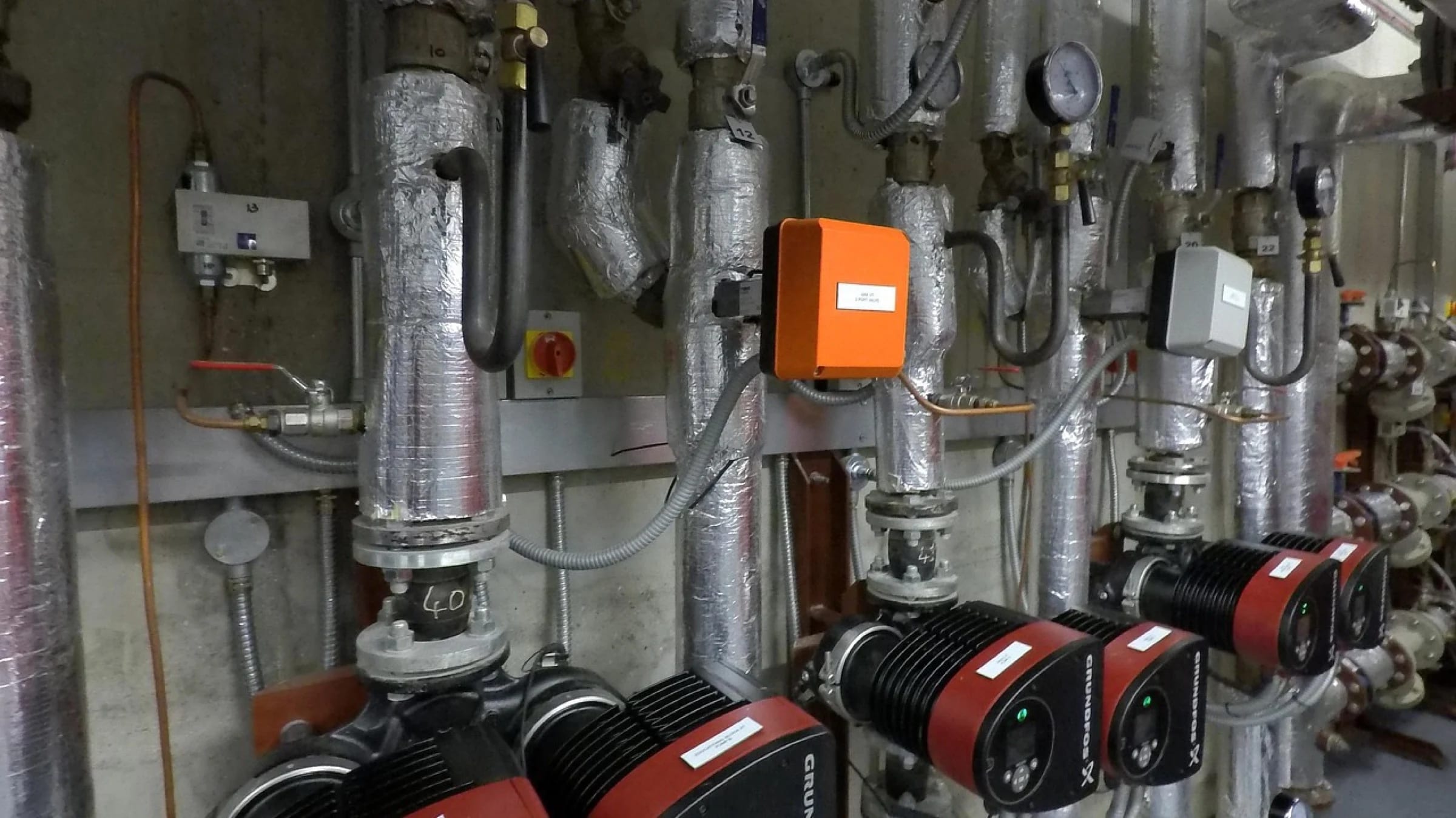 Industrial district-heating pipework, pumps and valves.