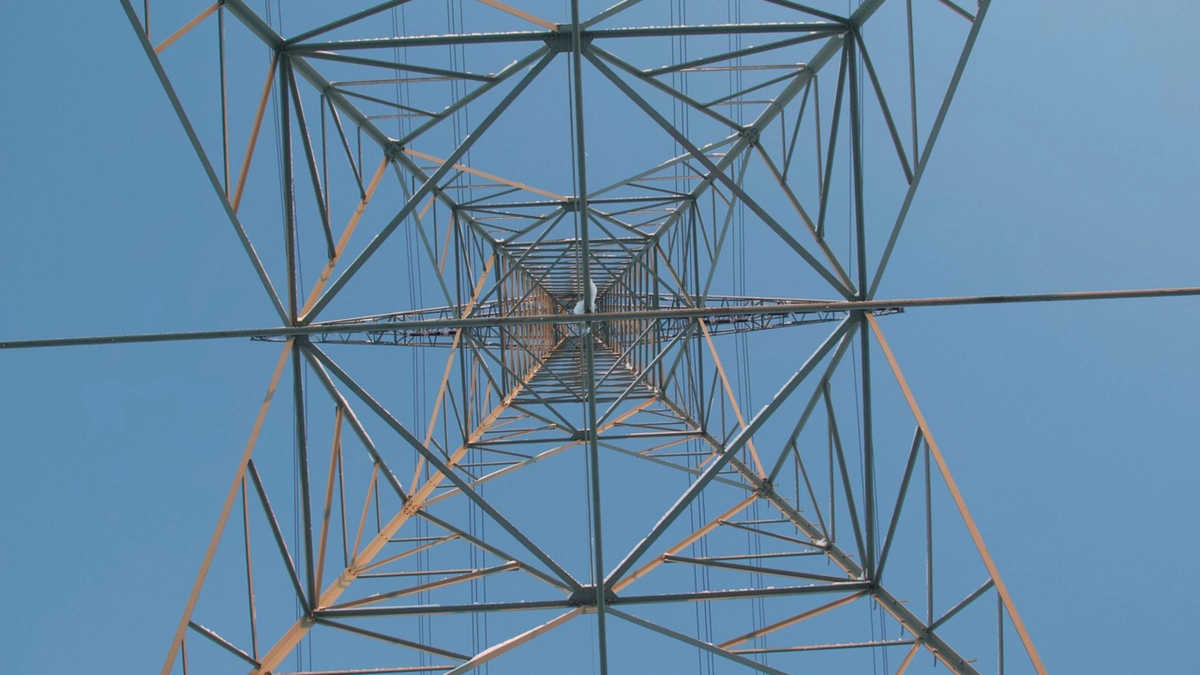 Electricity pylon and wires viewed from below.