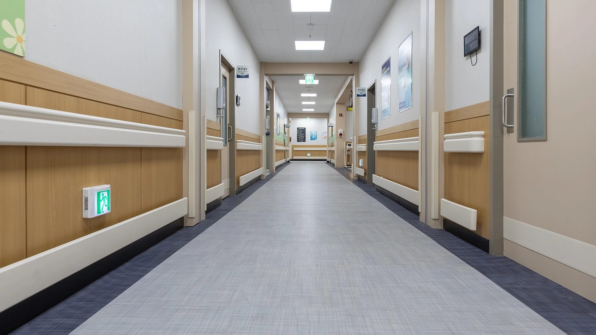 Empty modern hospital corridor with rooms on either side
