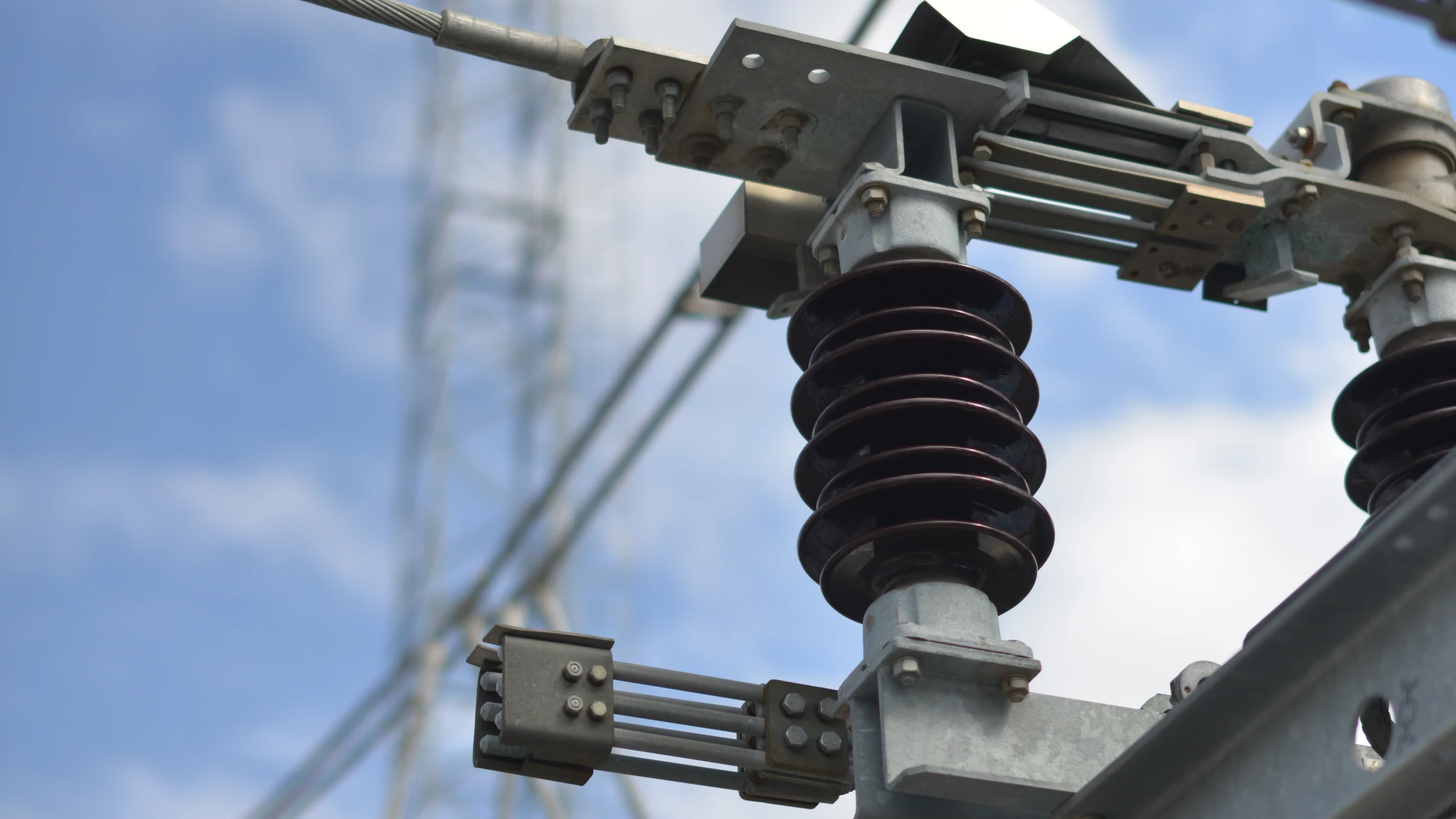 Close-up of electrical substation insulators and equipment