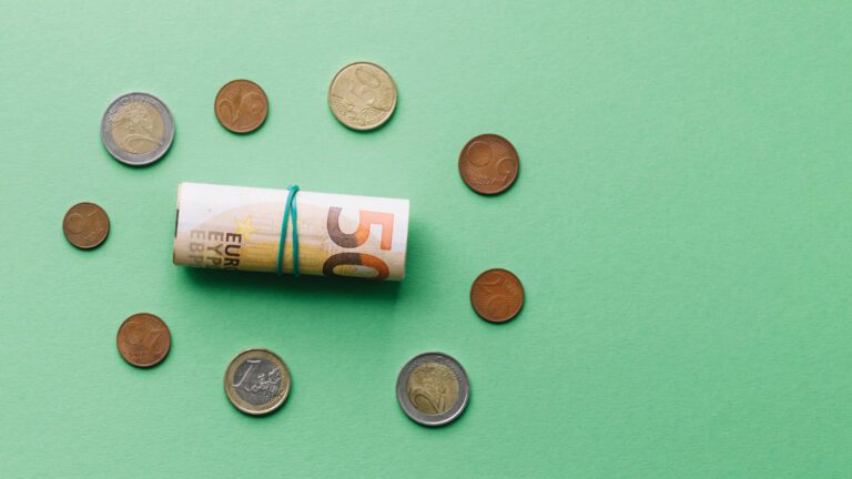 Euro coins and rolled banknote representing capital markets and financing mechanisms for urban water infrastructure investment