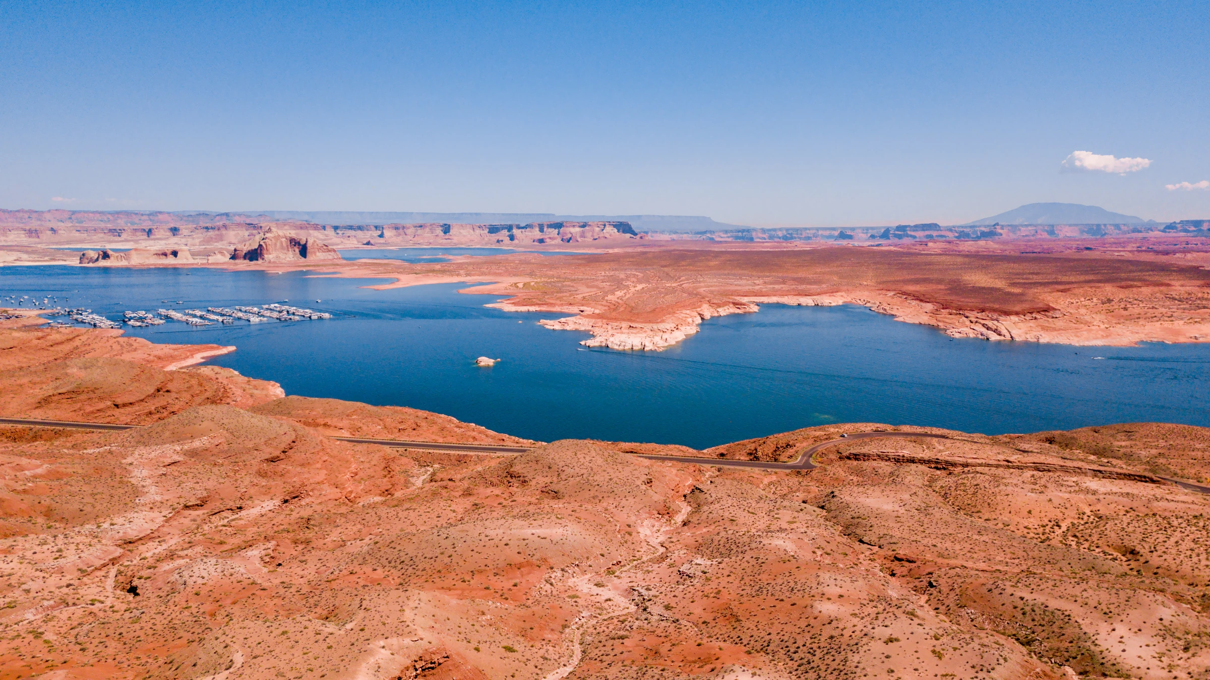 Aerial view of Lake Powell and Glen Canyon Dam in the desert landscape.