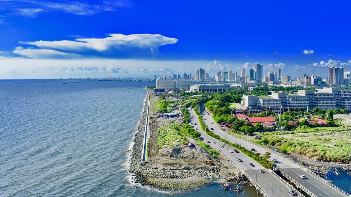 Manila’s coastline, roads and urban skyline beside Manila Bay.