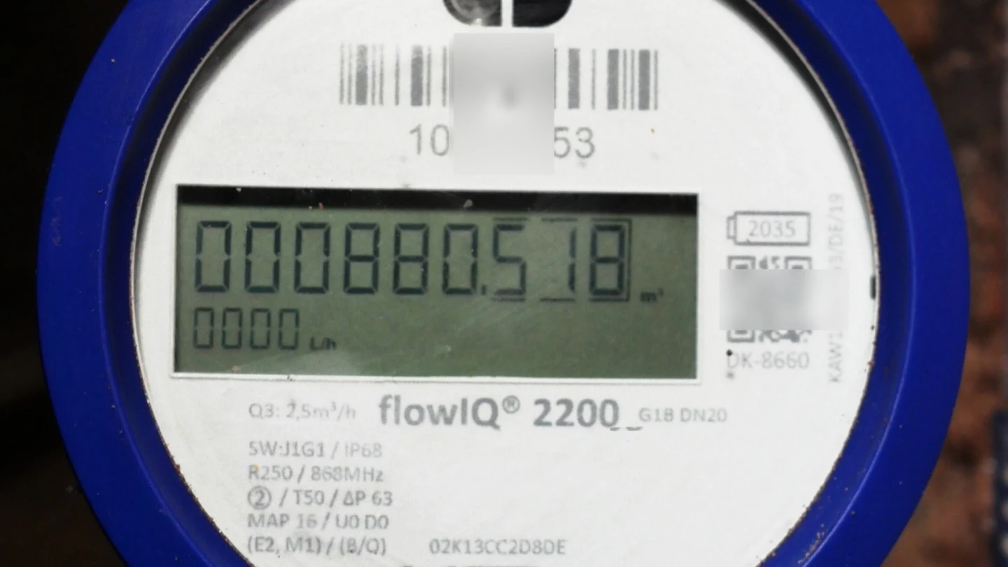 Close view of a blue digital radio water meter displaying a consumption reading.