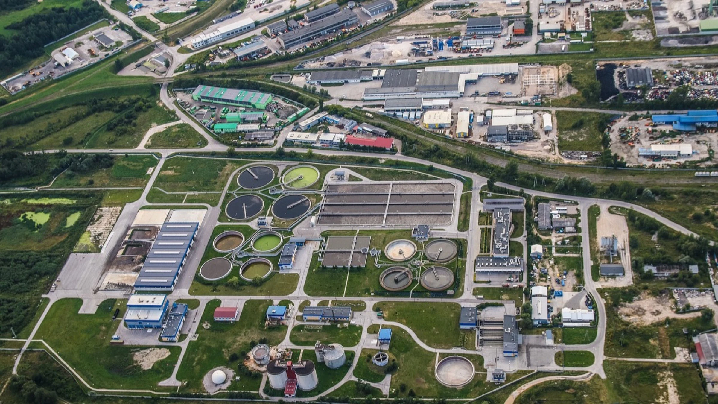 Circular tanks and channels at a wastewater-treatment plant viewed from above.