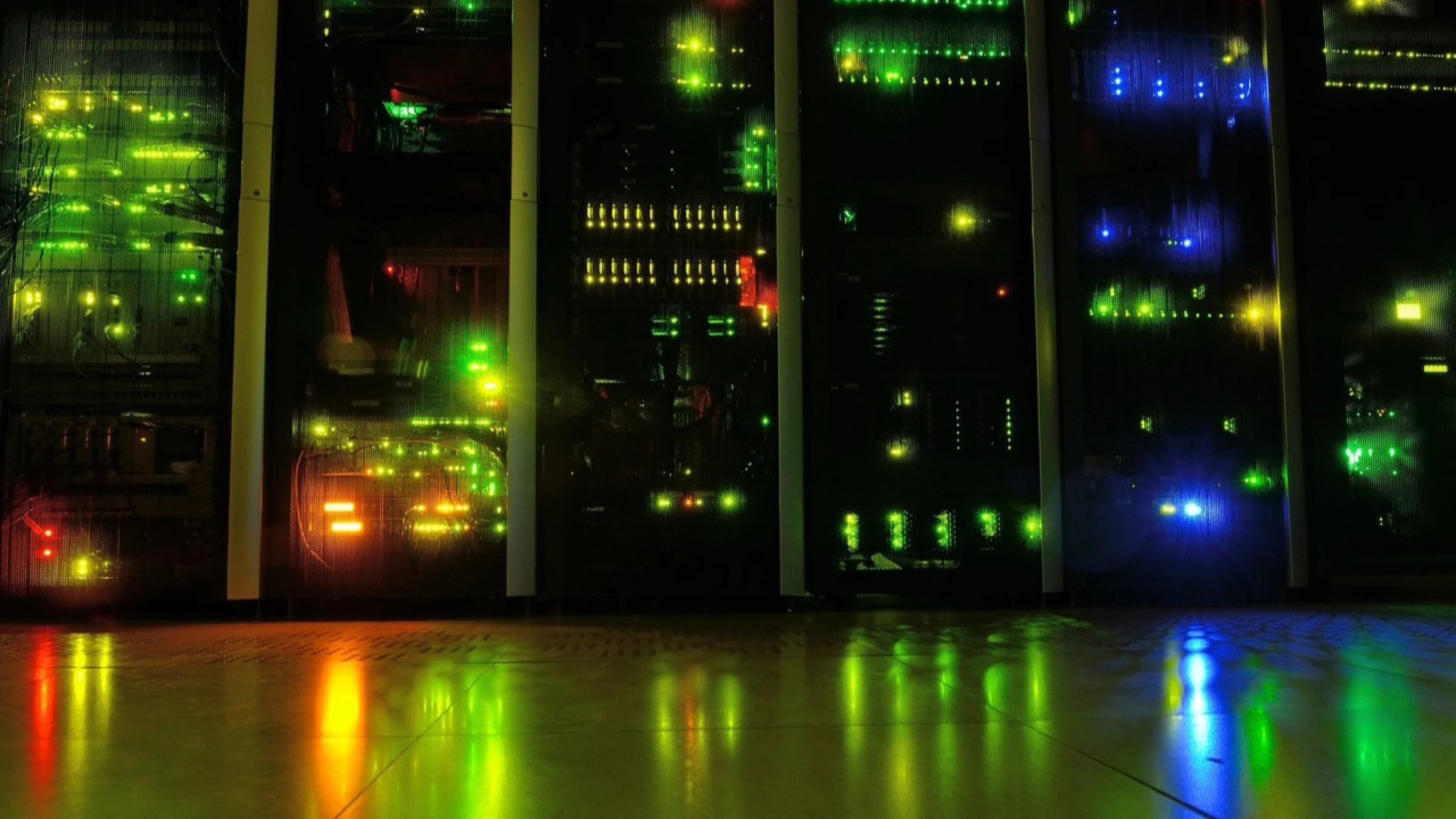Illuminated server racks in a dark data center.