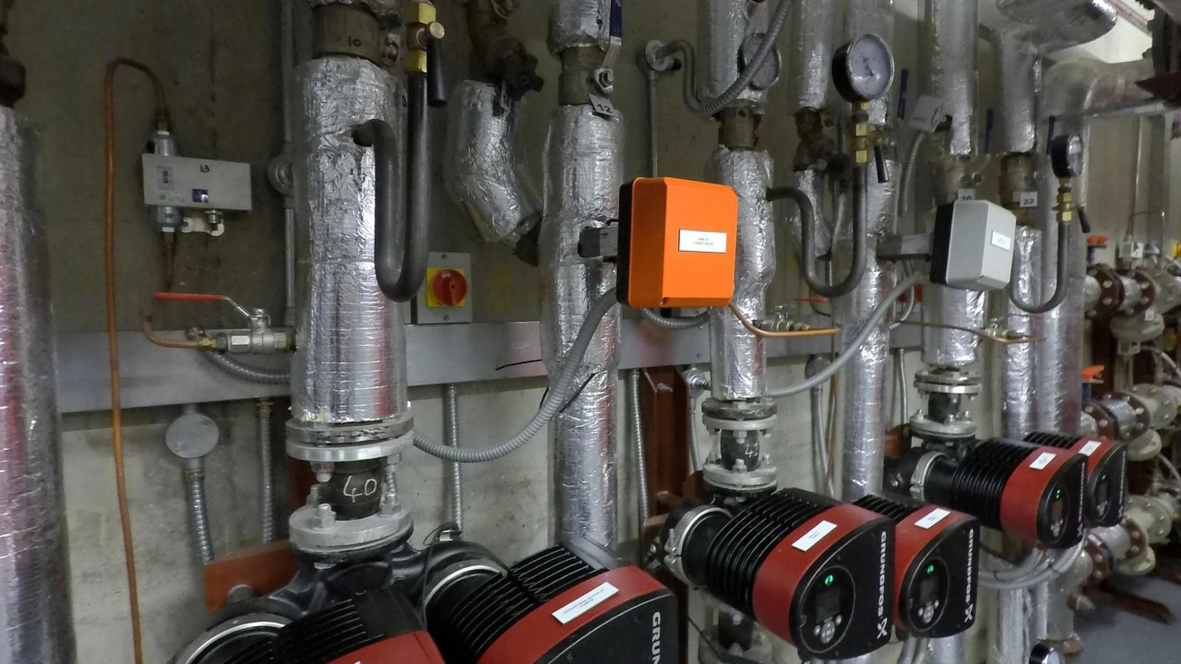 Industrial district-heating pipework, pumps and valves.