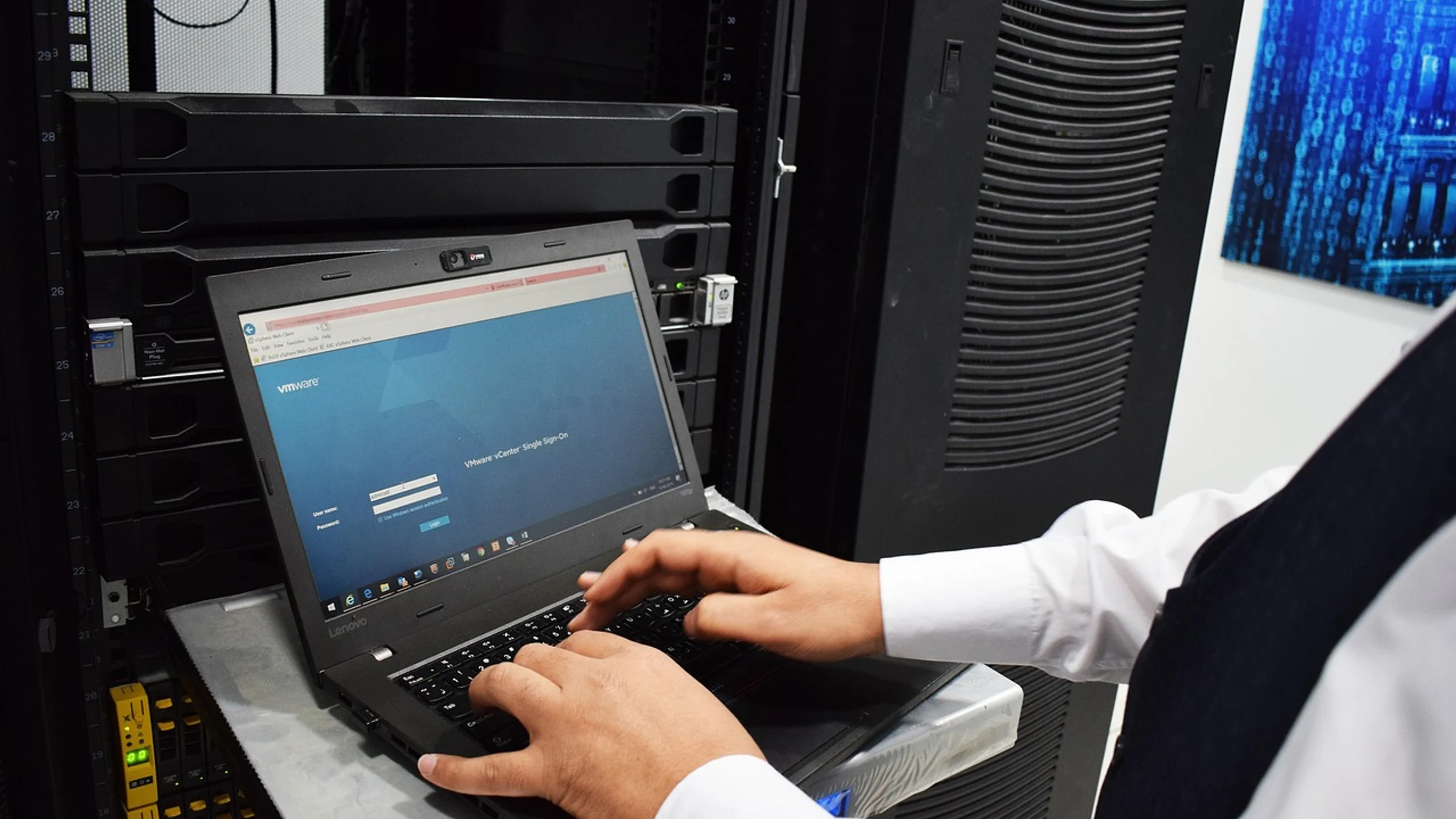Rows of equipment and cabling inside a data centre.