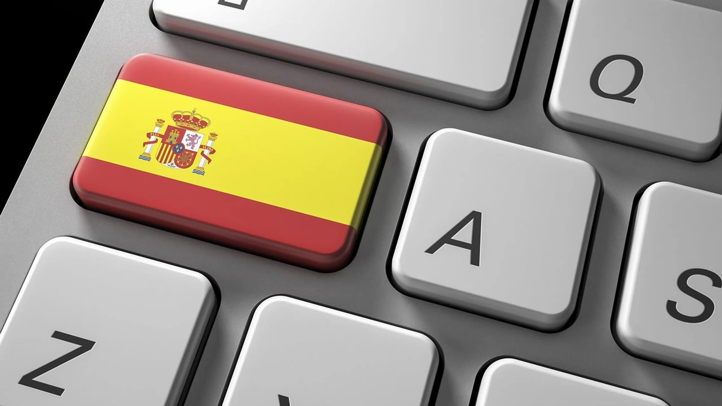 A computer keyboard with a key displaying the Spanish flag.