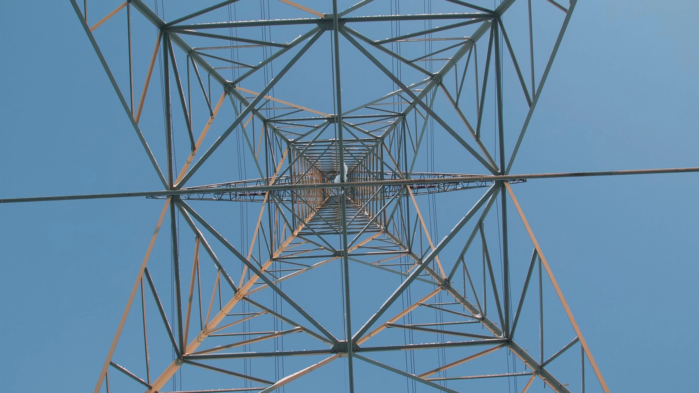 Electricity pylon and wires viewed from below.
