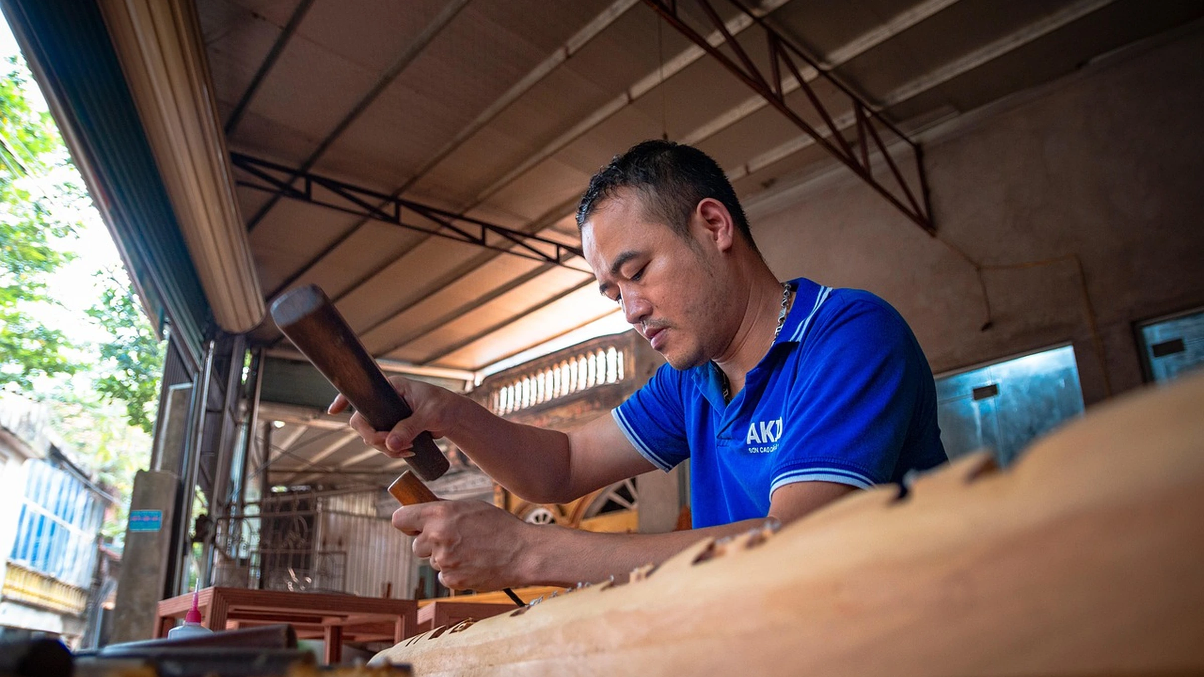 Woodworker using hand tools at a workbench