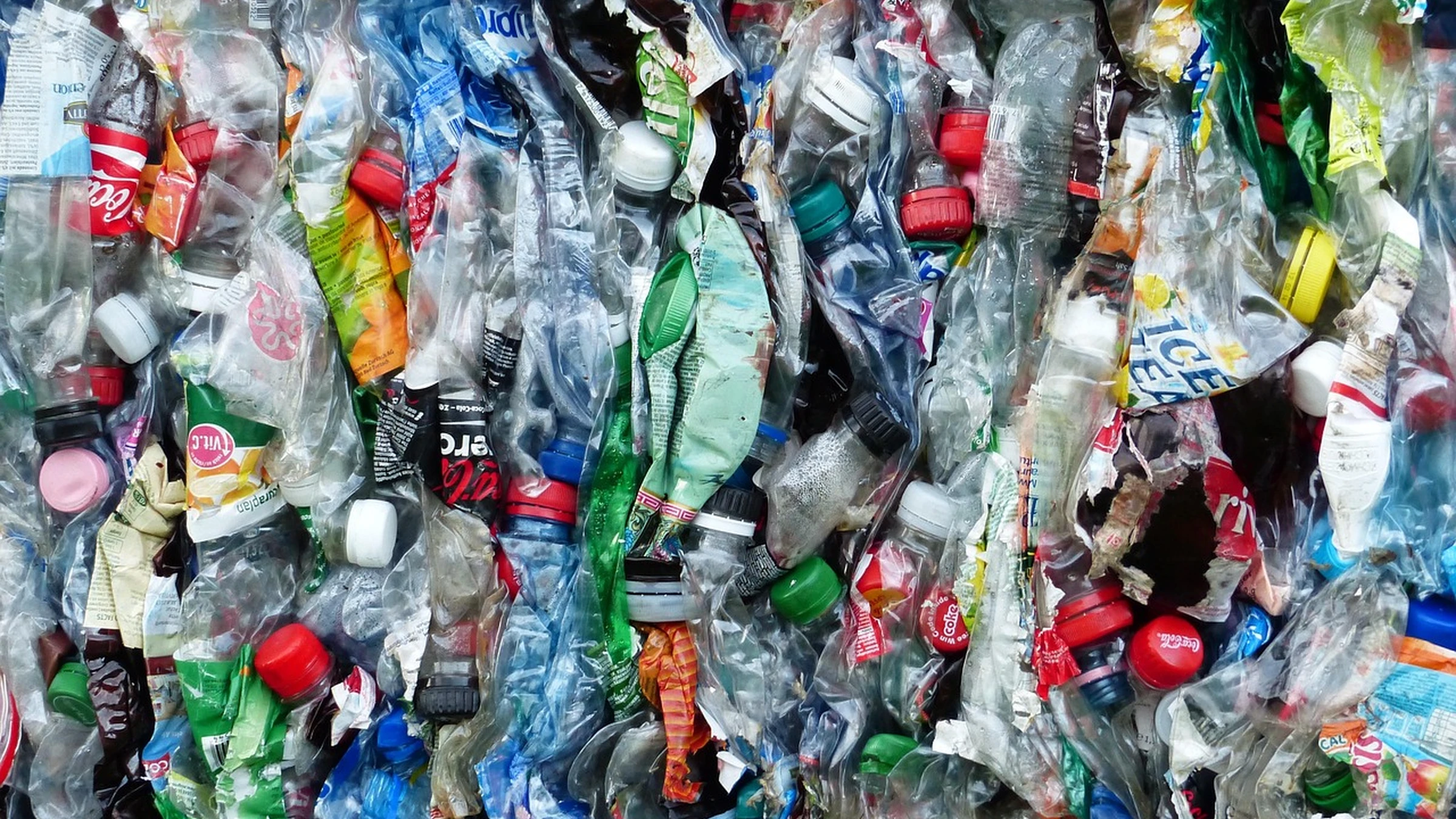 Compressed plastic bottles prepared as recycling material