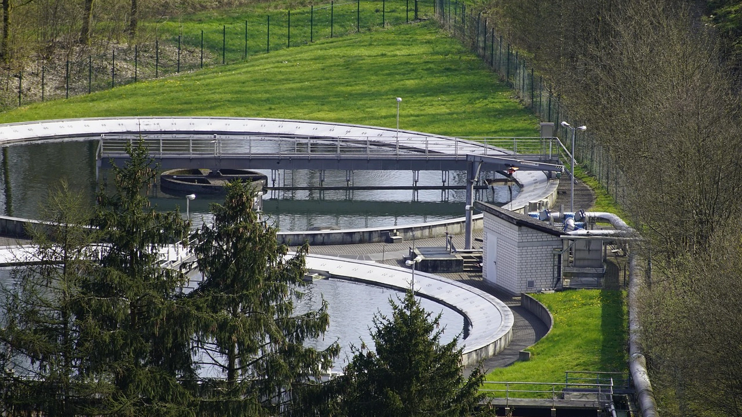Circular wastewater treatment tanks with access walkways.