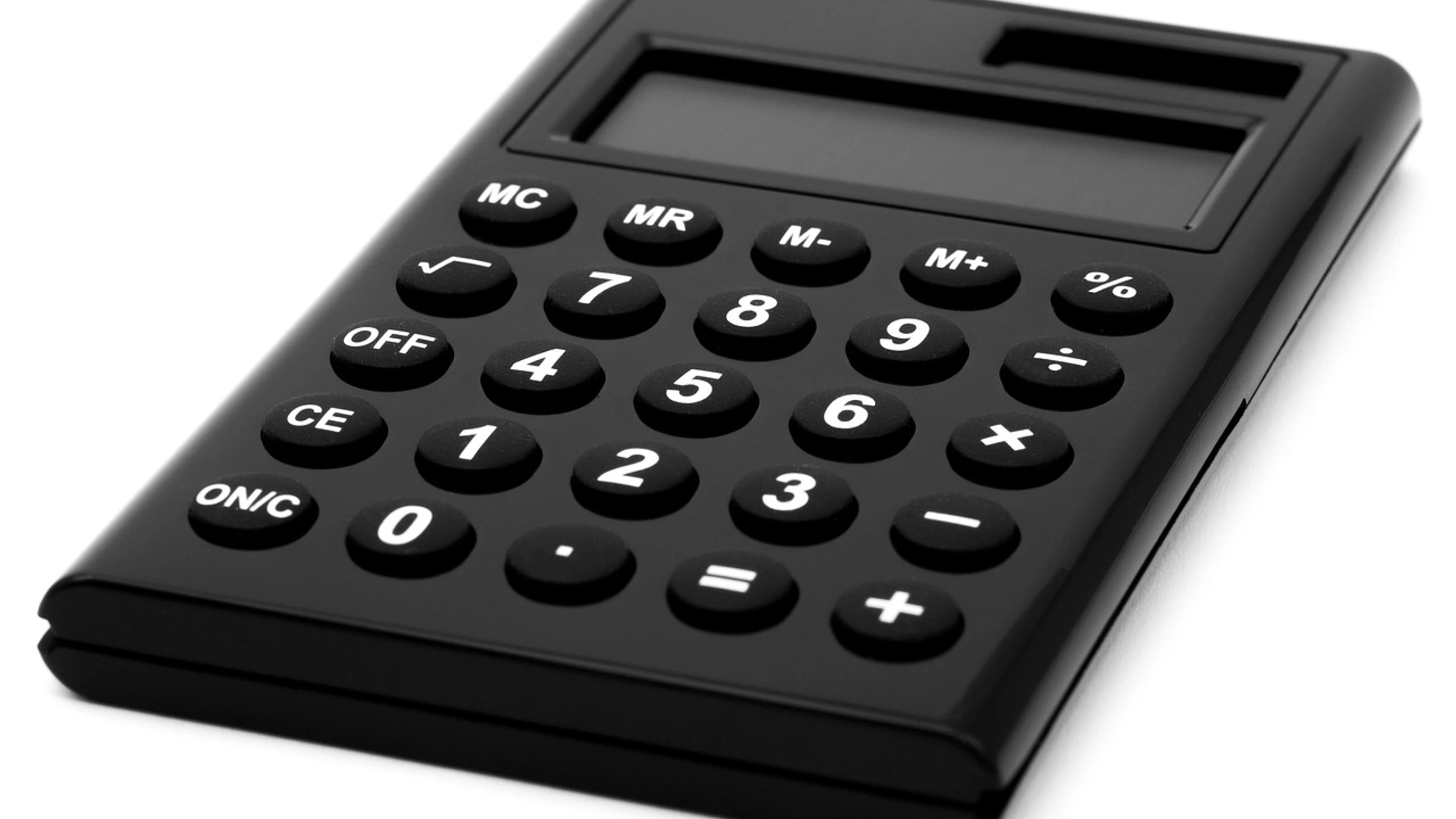Black solar calculator on a white surface.