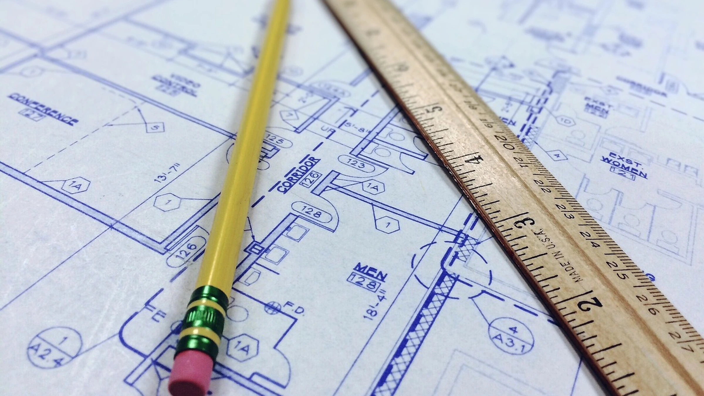 Ruler and pencil lying across architectural plans