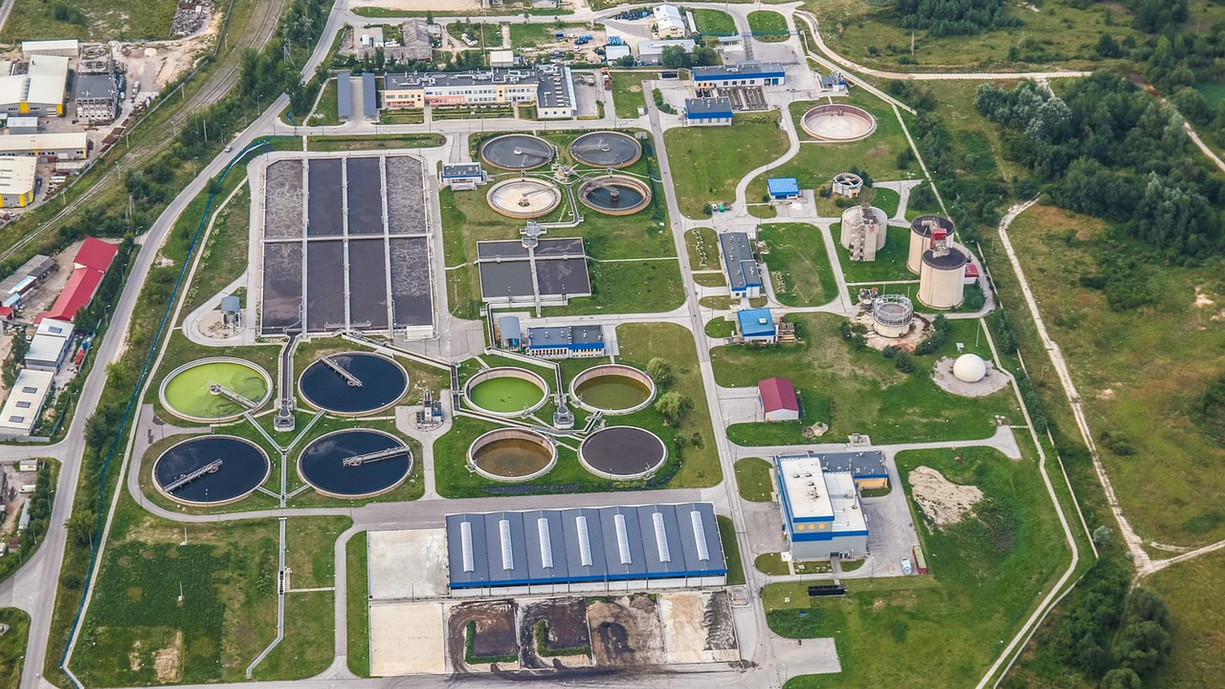 Aerial view of wastewater treatment basins and surrounding buildings