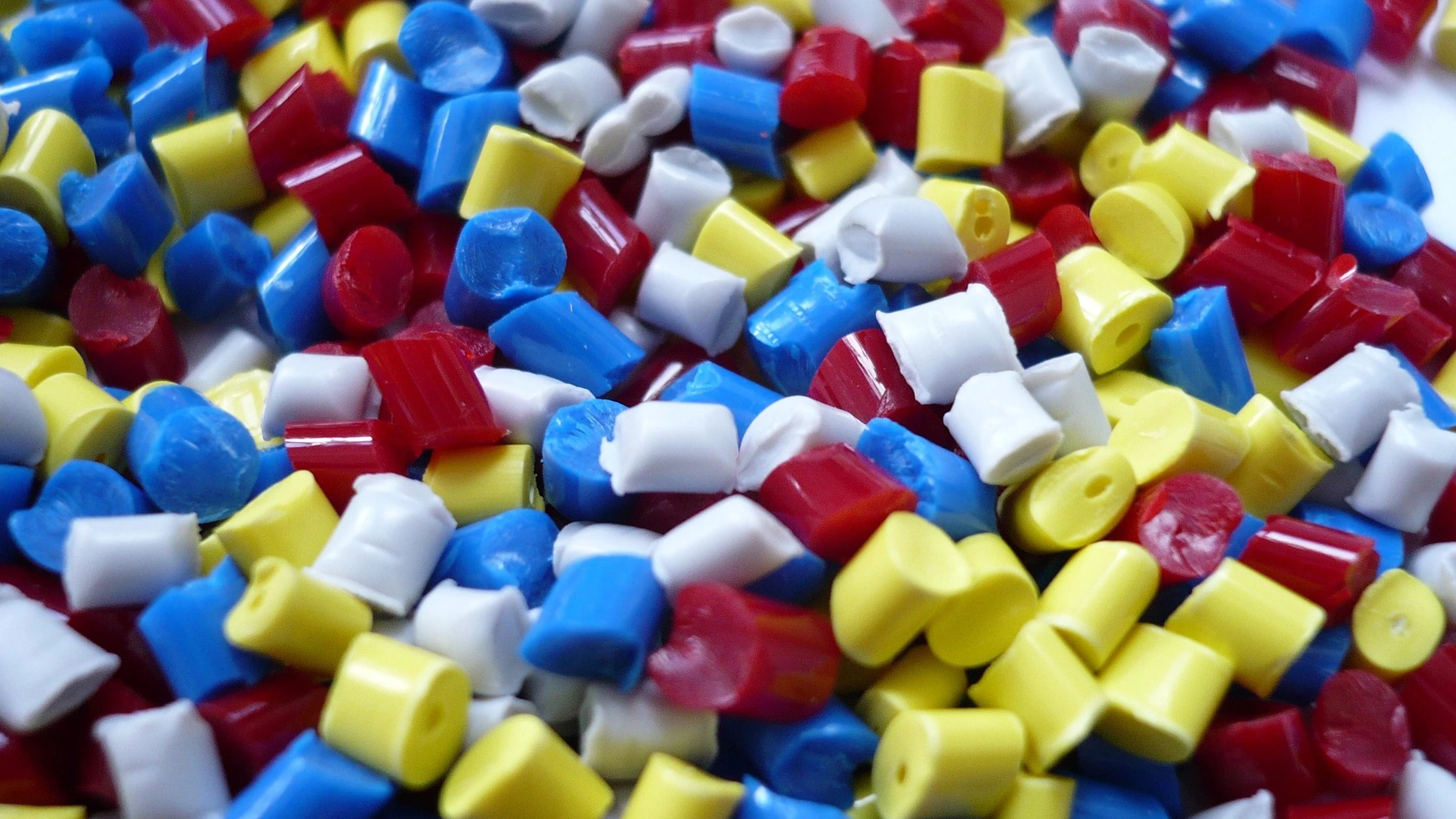 Close-up of coloured plastic polymer granules.