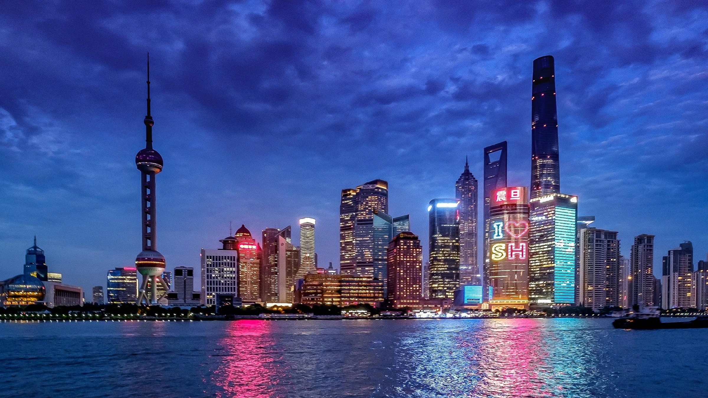 Shanghai skyline at dusk along the Huangpu River.